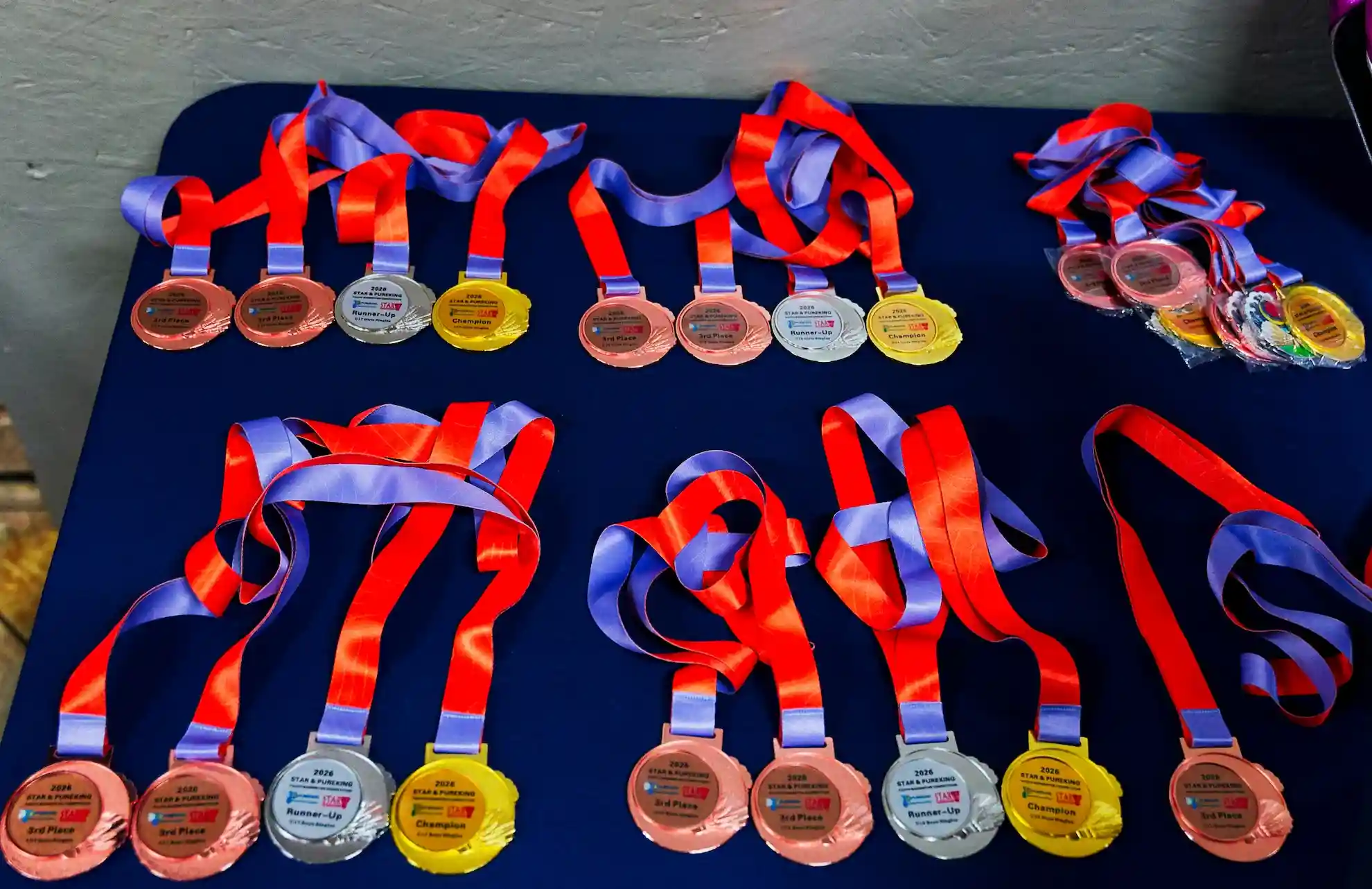 Rows of PureKing tournament medals