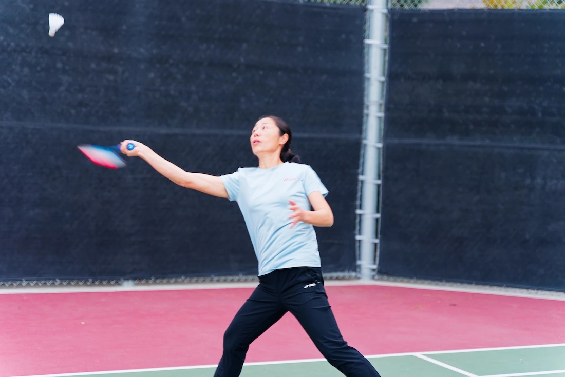 A coach demonstrating badminton technique